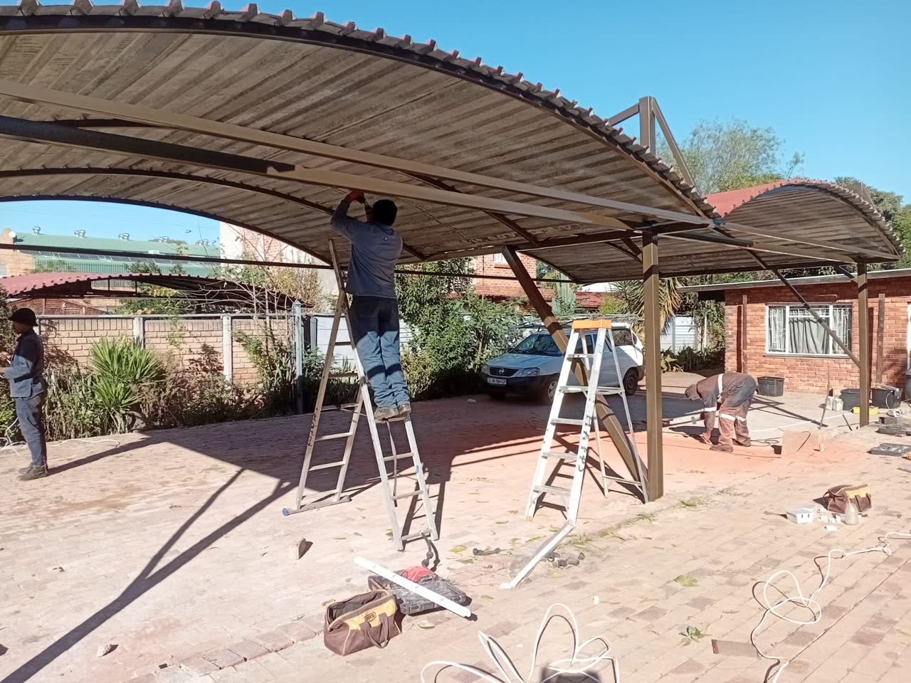 Happ's Electrical & Maintenance team installing a steel carport structure at a Gauteng property